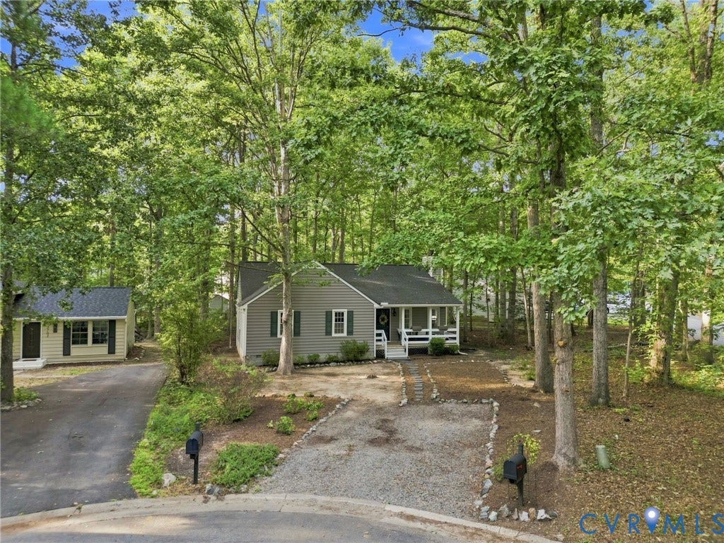 13700 Carriage Creek Place, Chesterfield, VA 23112 Siding exterior with a covered front porch, white railings, and green shutters