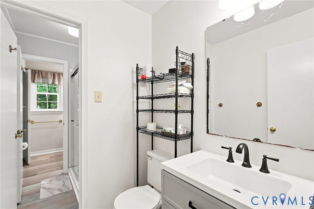 13700 Carriage Creek Place, Chesterfield, VA 23112 White vanity with integrated sink, matte black faucet, and frameless mirror