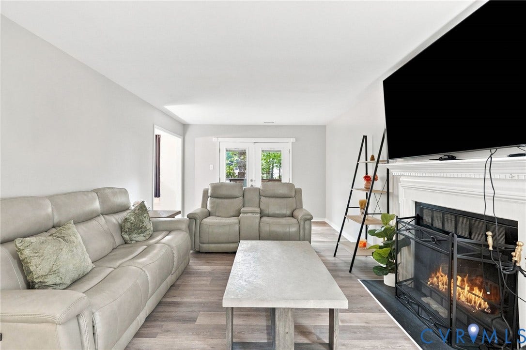 13700 Carriage Creek Place, Chesterfield, VA 23112 Wood-finish flooring, white walls, and a fireplace with a decorative mantel and hearth