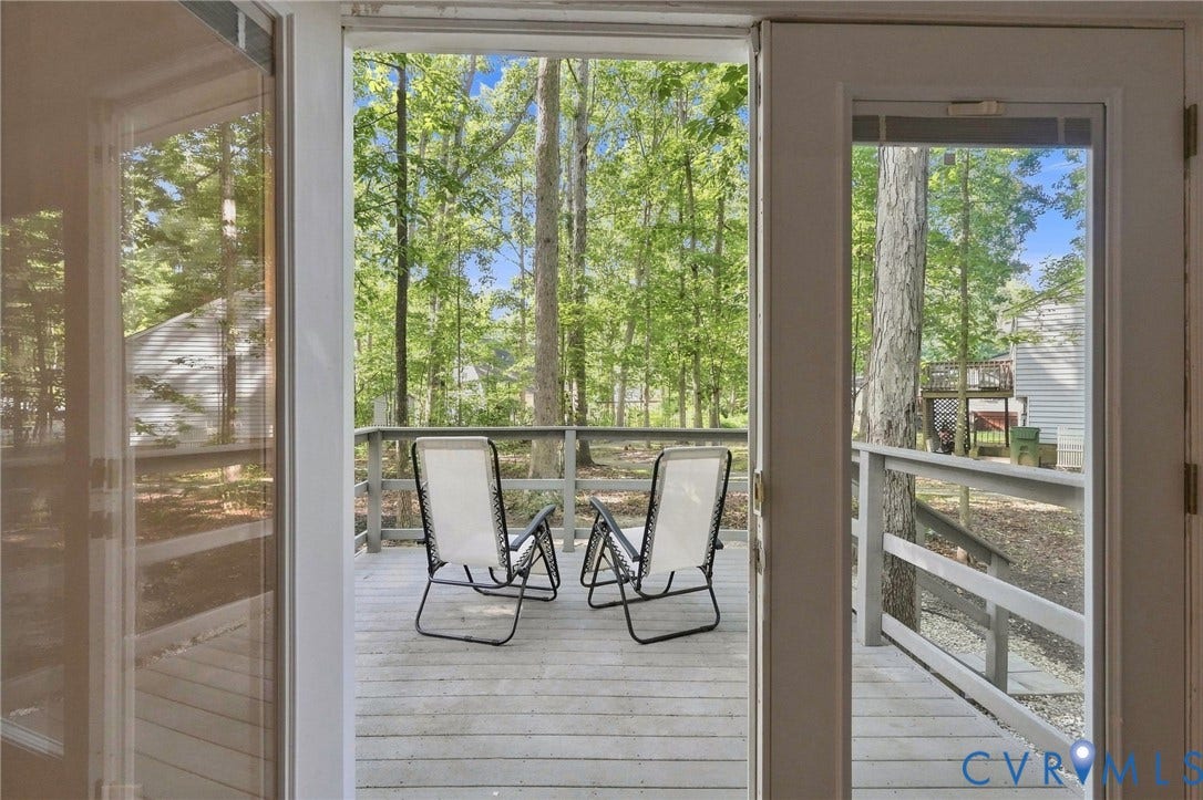 13700 Carriage Creek Place, Chesterfield, VA 23112 Exterior decking with a wooden railing and a treed backdrop