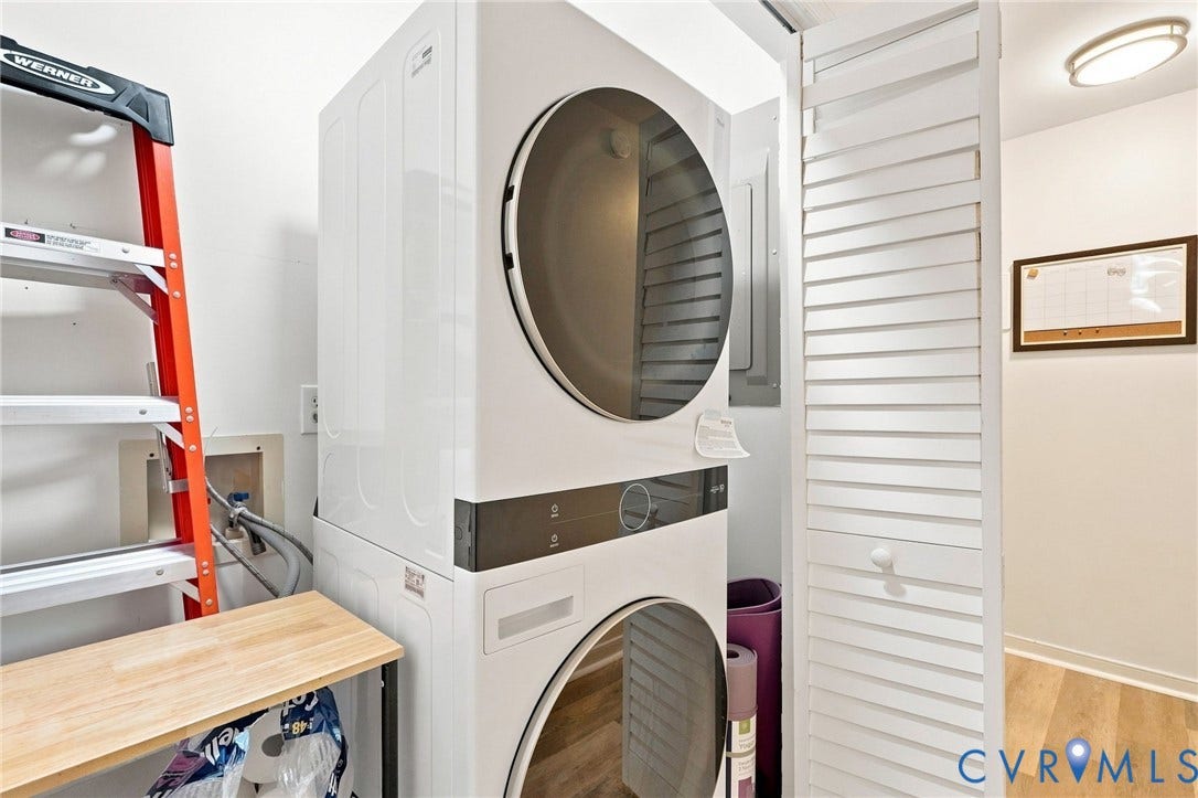 13700 Carriage Creek Place, Chesterfield, VA 23112 Stacked washer and dryer units, louvered bi-fold door, and light wood-finish flooring