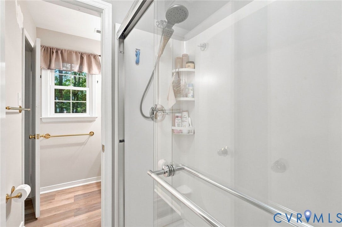 13700 Carriage Creek Place, Chesterfield, VA 23112 Shower enclosure with clear glass door, chrome fixtures, and integrated shelving
