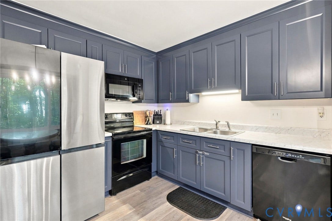 13700 Carriage Creek Place, Chesterfield, VA 23112 Kitchen featuring slate-blue cabinetry, light-toned countertops, a stainless steel refrigerator, a black range, and a black dishwasher