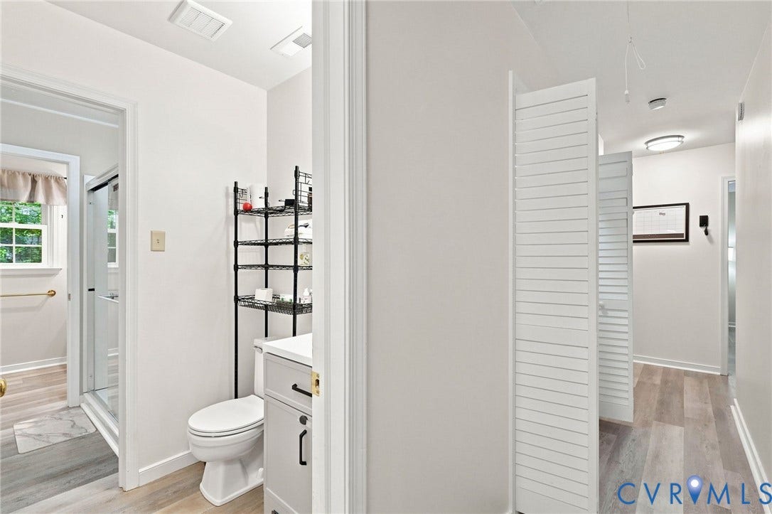 13700 Carriage Creek Place, Chesterfield, VA 23112 White vanity with black hardware, white toilet, glass-enclosed shower, and wood-finish flooring