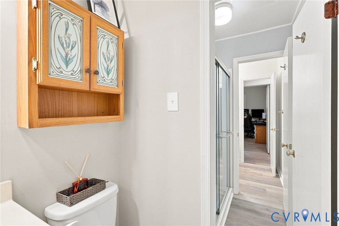 13700 Carriage Creek Place, Chesterfield, VA 23112 Wood-finish flooring, glass-enclosed shower, wall-mounted storage cabinet, and white trim