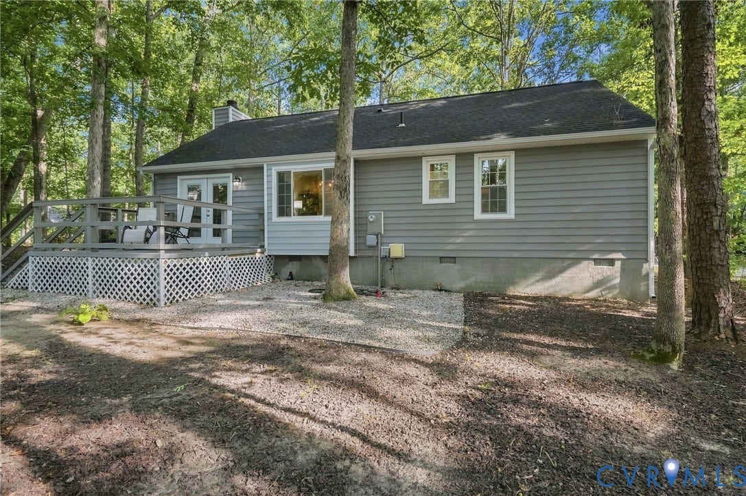 13700 Carriage Creek Place, Chesterfield, VA 23112 Expansive rear deck with lattice skirting and direct access, complemented by gray horizontal siding and a dark shingle roof