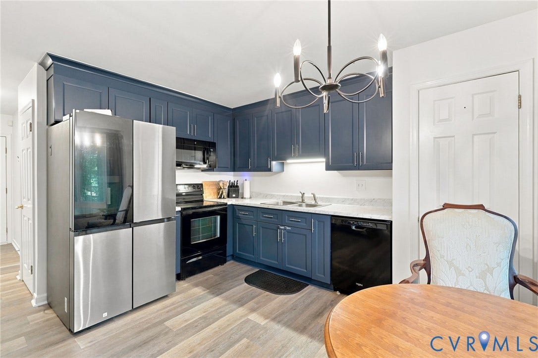 13700 Carriage Creek Place, Chesterfield, VA 23112 Kitchen featuring slate blue cabinetry, stainless steel appliances, light-toned wood-finish flooring, and a contemporary chandelier