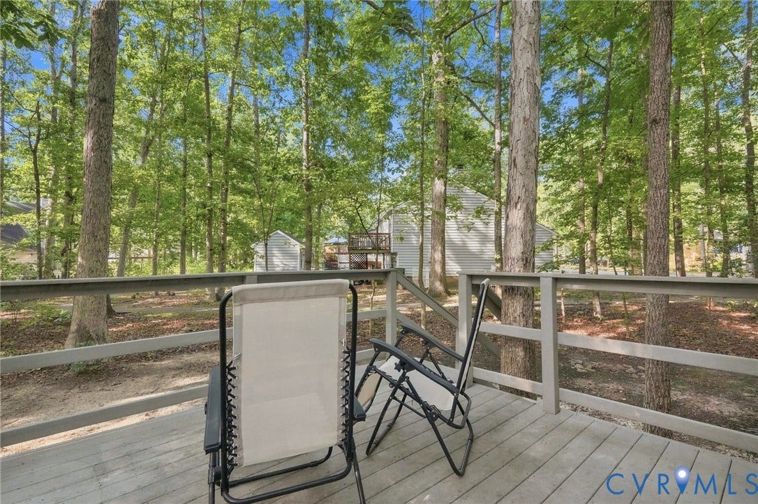 13700 Carriage Creek Place, Chesterfield, VA 23112 Expansive outdoor deck featuring a wooden railing and mature trees