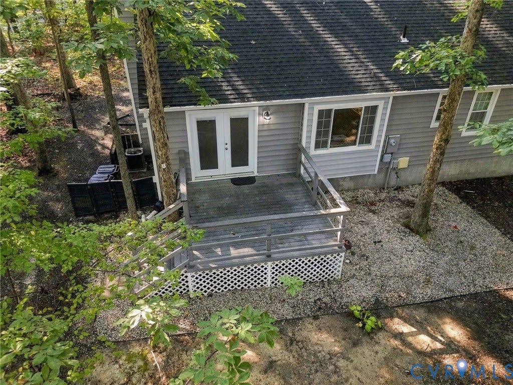 13700 Carriage Creek Place, Chesterfield, VA 23112 Exterior featuring gray siding, a dark shingle roof, white-framed windows, and a wooden deck with railings