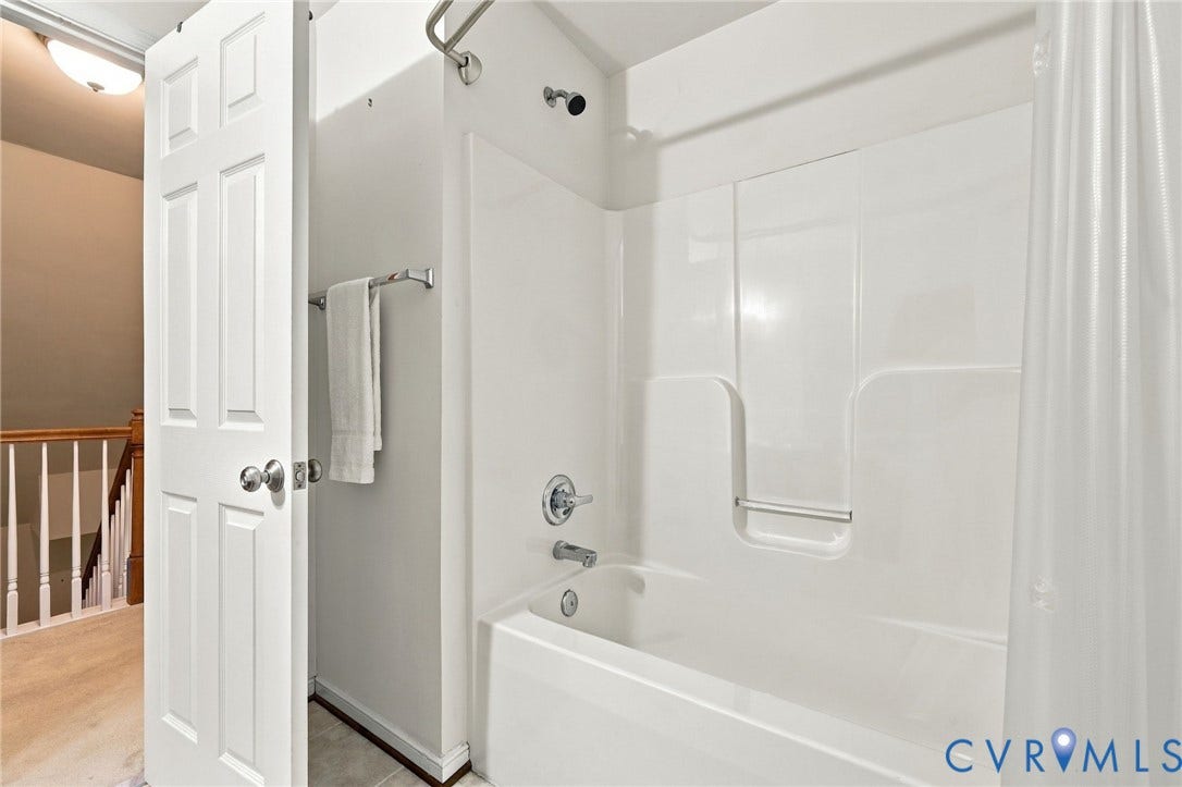 9619 Redwick Drive, Matoaca, Chesterfield, VA 23112 White bathtub with an integrated shower, chrome fixtures, and a curved shower rod