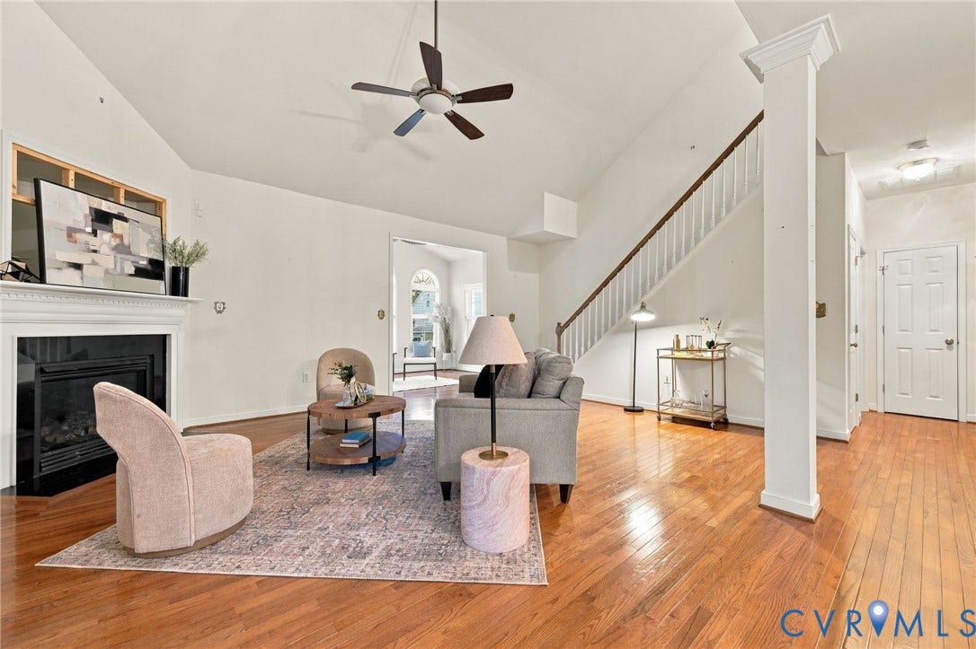 9619 Redwick Drive, Matoaca, Chesterfield, VA 23112 Vaulted ceiling with a ceiling fan, fireplace with a white mantel, wood-finish flooring, and a staircase with white balusters