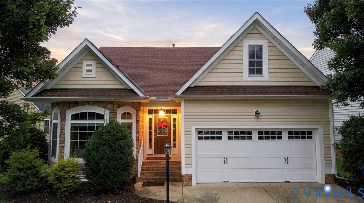 9619 Redwick Drive, Matoaca, Chesterfield, VA 23112 Charming brick and siding exterior featuring a covered front porch with arched entryway, dual gabled roofline, and a two-car garage with paneled doors