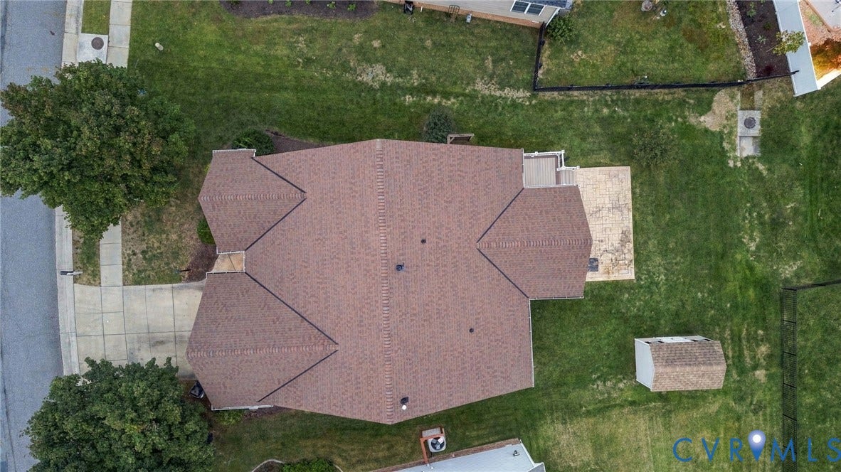 9619 Redwick Drive, Matoaca, Chesterfield, VA 23112 Pitched roof with asphalt shingles, expansive lawn, concrete patio, and detached storage shed