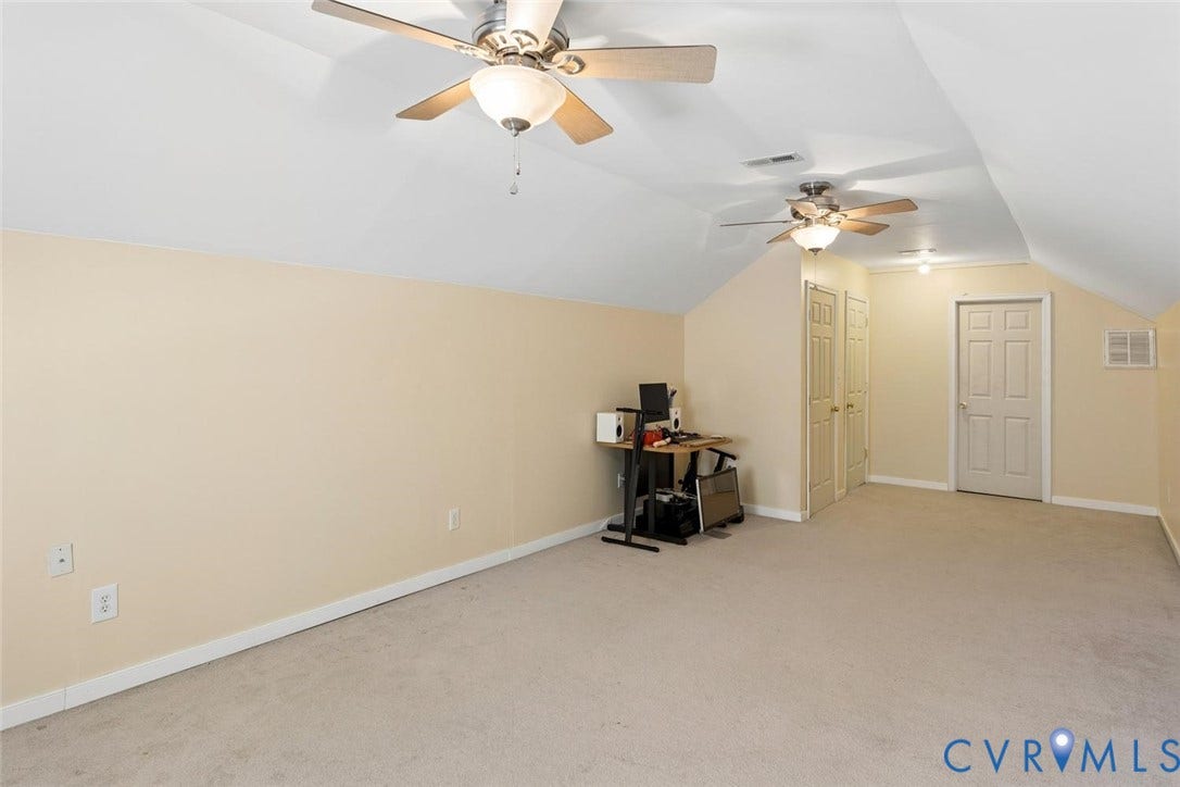 conditioned 3rd floor flex space. Closet to left and attic storage at end