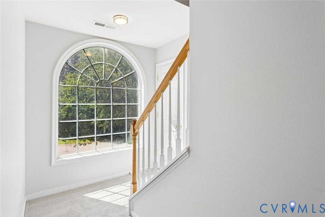 large window and stairs to 3rd floor