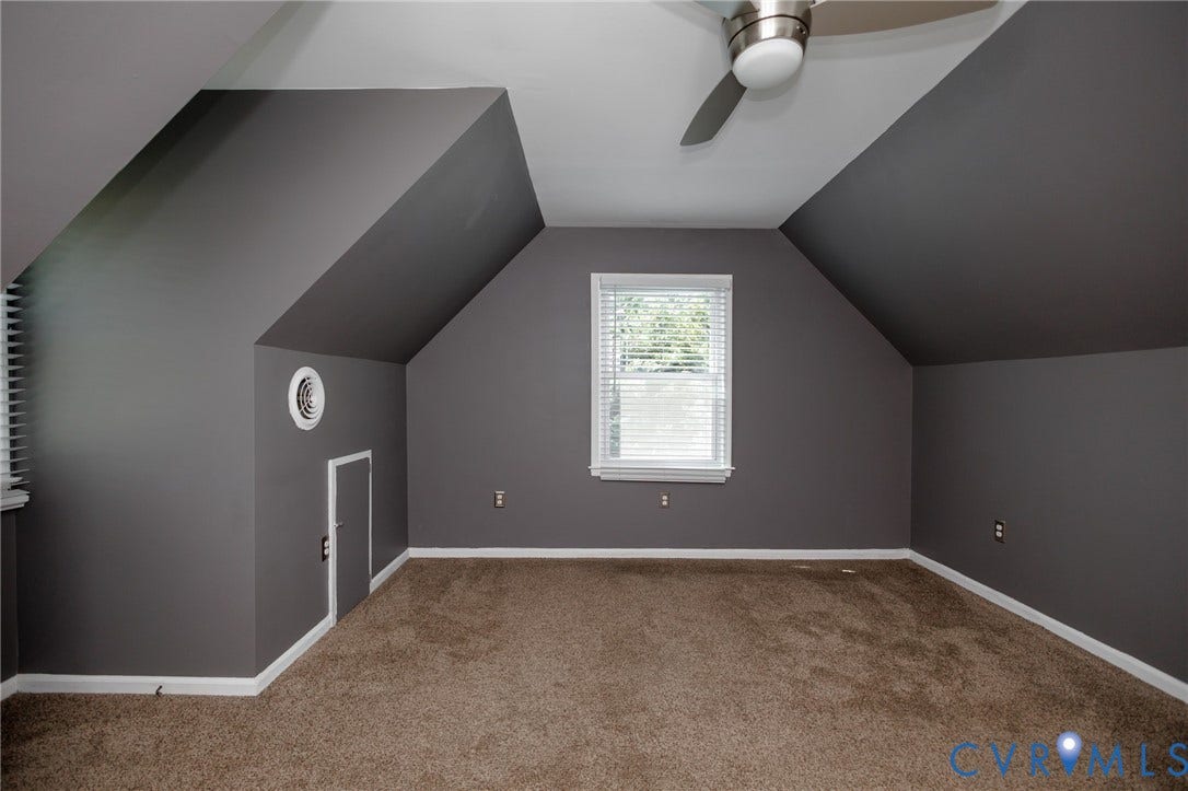 20520 Cox Road, Sutherland, VA 23885 Carpeted room with sloped ceilings, a window with blinds, and a ceiling fan