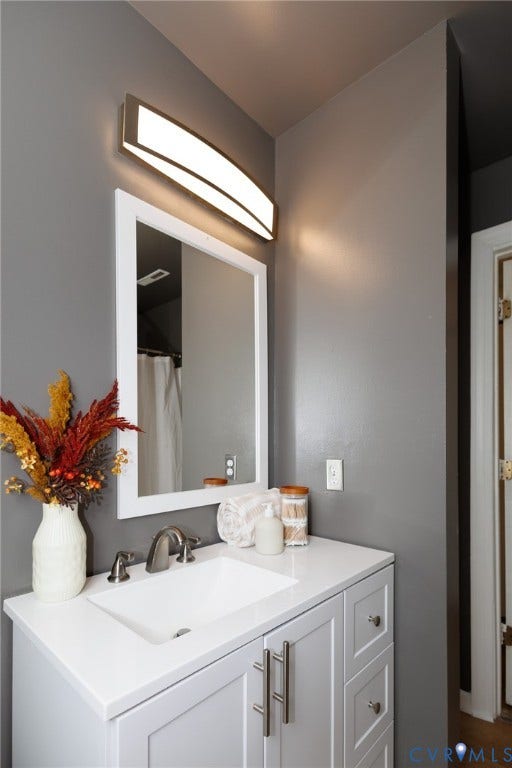 20520 Cox Road, Sutherland, VA 23885 White vanity with shaker-style cabinetry, an integrated sink, and brushed nickel hardware