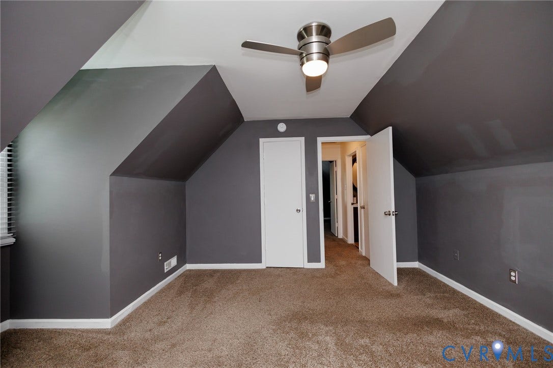 20520 Cox Road, Sutherland, VA 23885 Angled ceiling with a contemporary ceiling fan, plush carpet, white trim, and a white door with brushed nickel hardware