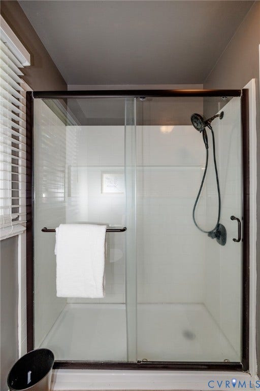 20520 Cox Road, Sutherland, VA 23885 Glass-enclosed shower with dark bronze framing and a wall-mounted shower head