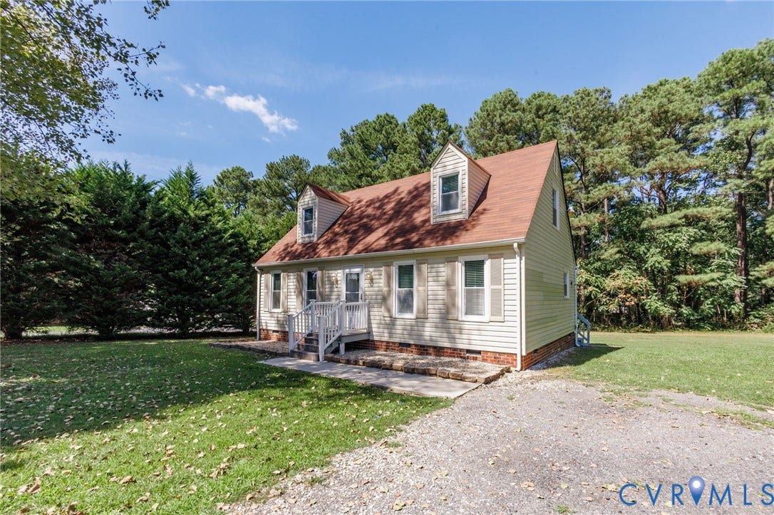 20520 Cox Road, Sutherland, VA 23885 Gable roofline with dormer windows, light-toned siding, and a gravel driveway