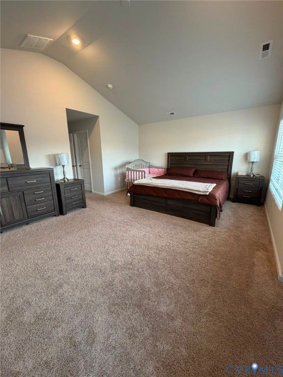 Vaulted ceiling, recessed lighting, and soft carpet flooring