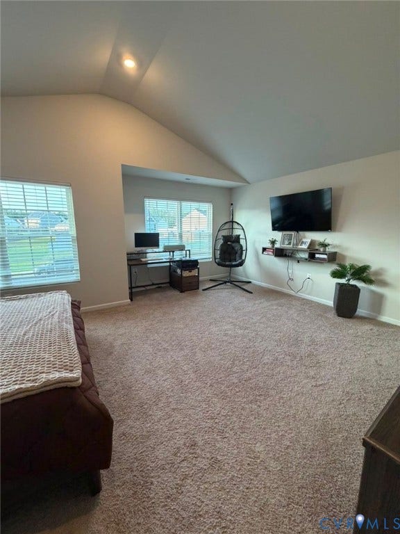 Expansive room featuring a vaulted ceiling and recessed lighting