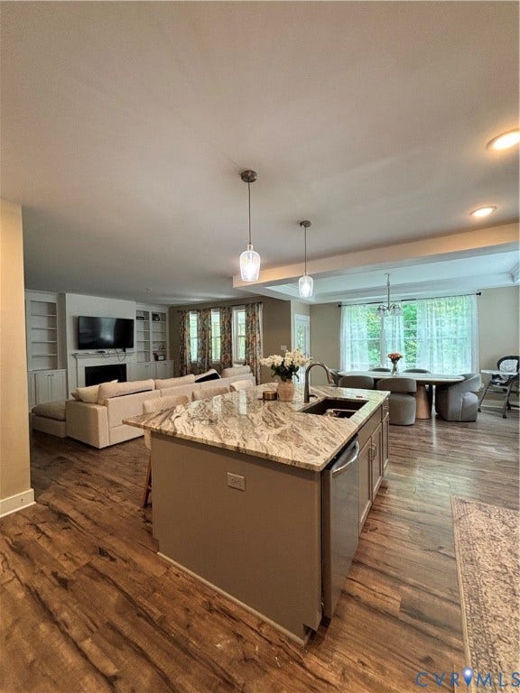 10963 Little Five Loop, Henrico, VA 23059 Open-concept living space with wood-finish flooring, a kitchen island with stone countertop, built-in cabinetry, and pendant lighting