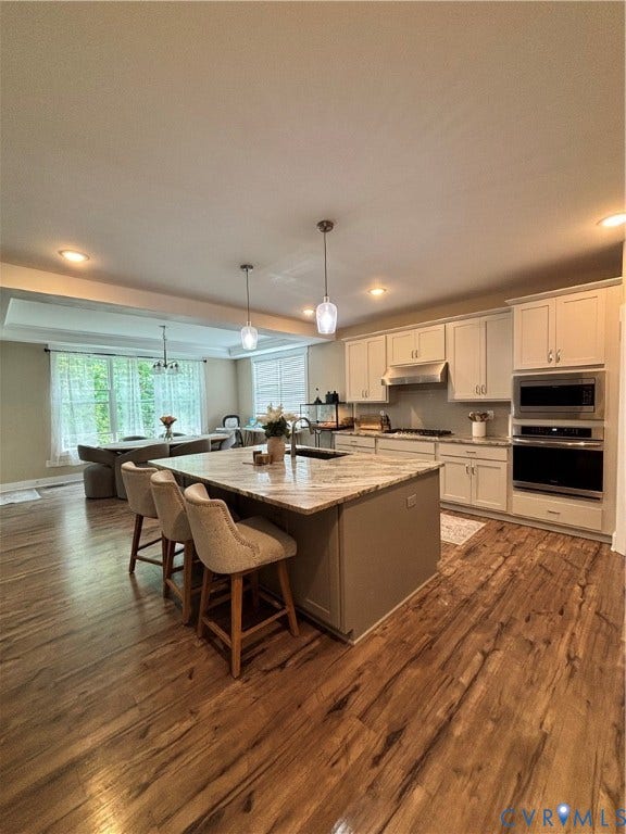 10963 Little Five Loop, Henrico, VA 23059 Wood-finish flooring throughout, kitchen island with stone countertop, recessed lighting, and stainless steel appliances