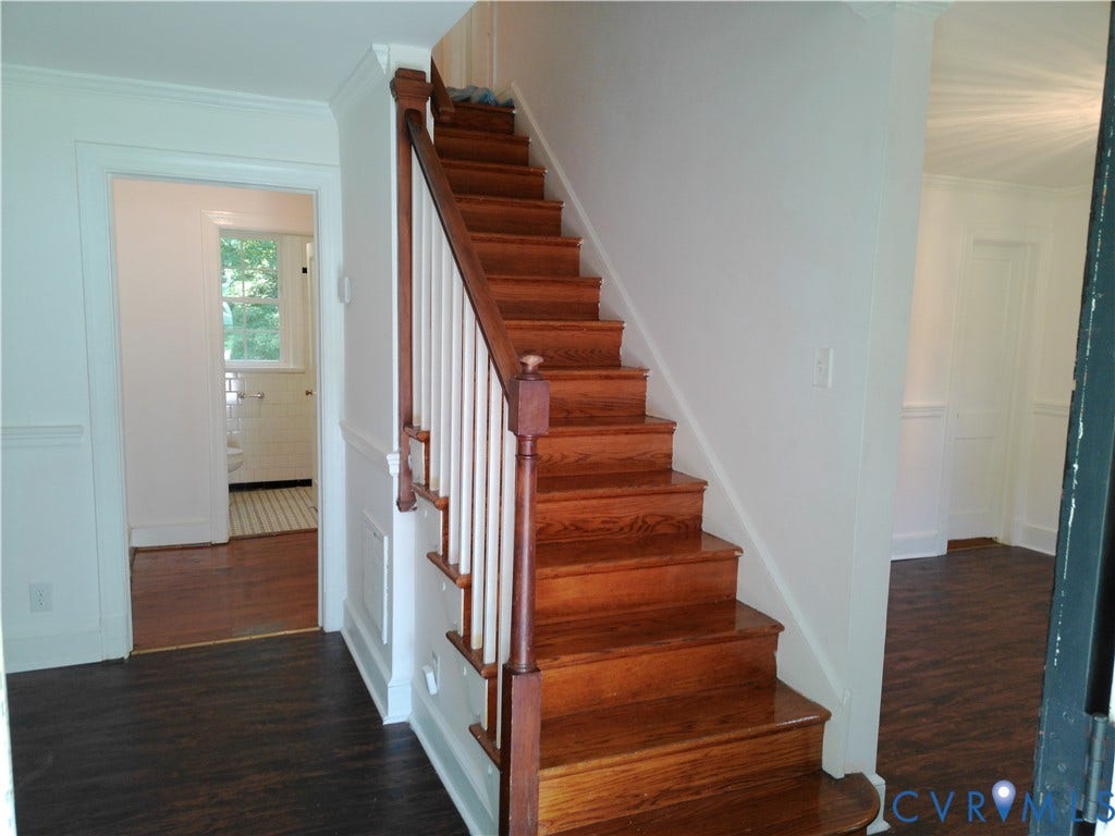 6902 Old Jahnke Road, Richmond, VA 23225 Hardwood staircase with white balusters, wood-finish flooring, and white wainscoting