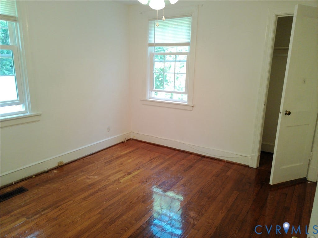 6902 Old Jahnke Road, Richmond, VA 23225 Hardwood flooring, two windows with blinds, ceiling fan, and a closet with a built-in shelf and hanging rod