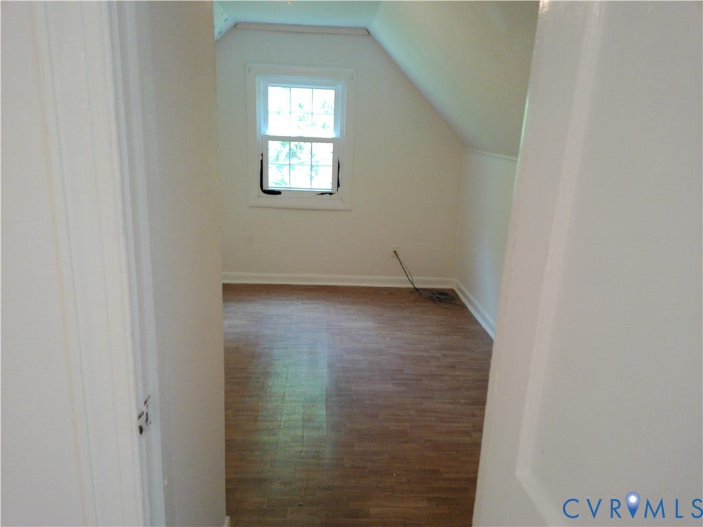 6902 Old Jahnke Road, Richmond, VA 23225 Recessed window with white trim, wood-finish flooring, and sloped ceiling
