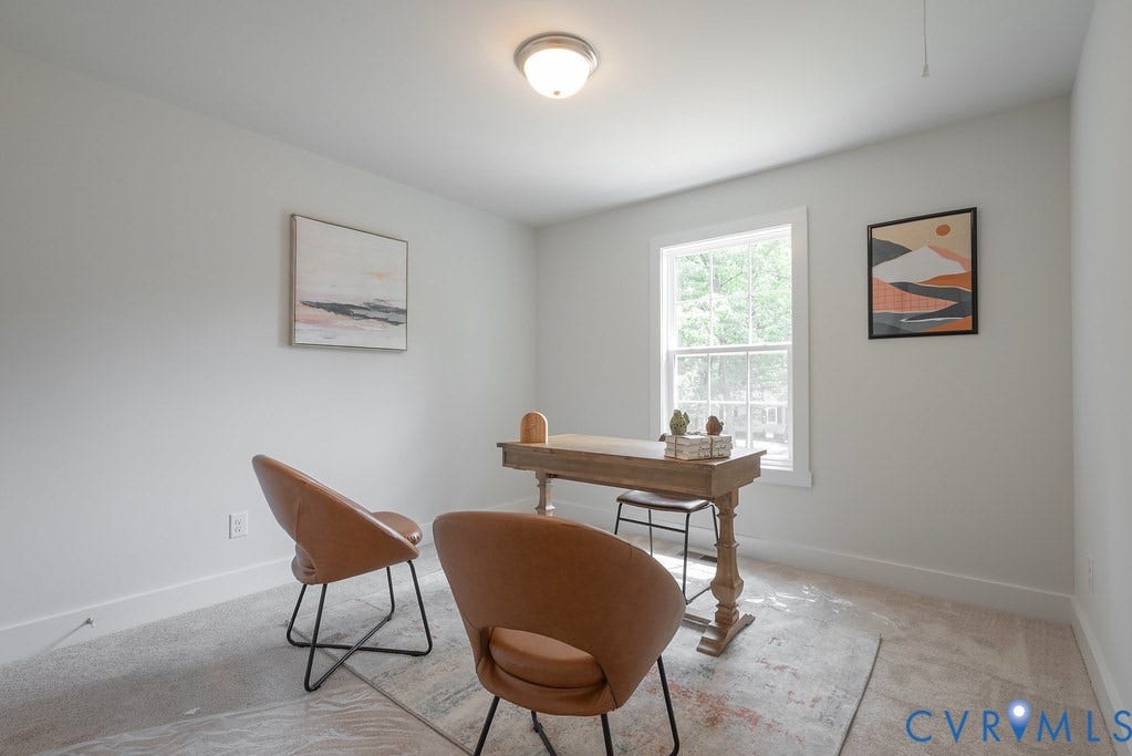 Recessed lighting, light-toned wall paint, carpet flooring, and a window with natural light