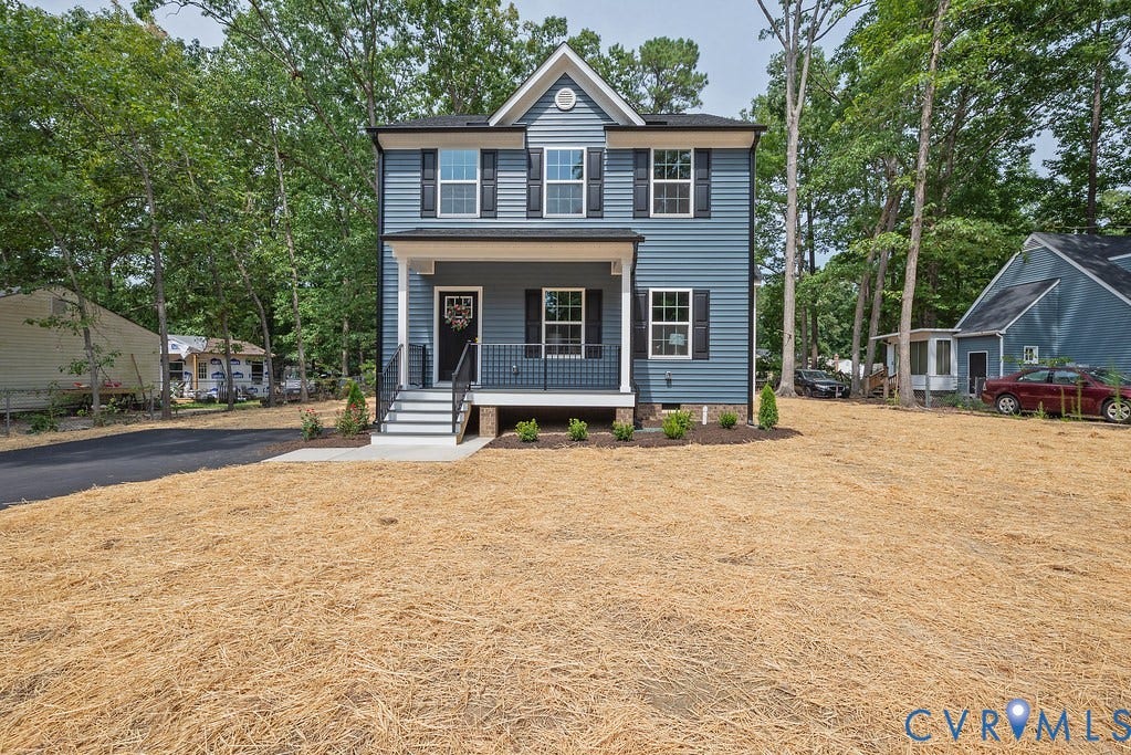 Two-story residence featuring blue siding, white trim, and black shutters