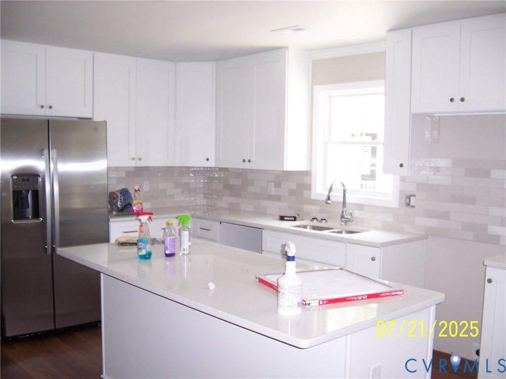 1805 Liesfeld Parkway, Henrico, VA 23060 Kitchen with stainless steel fridge, white cabinets, light countertops, a kitchen island, and tasteful backsplash
