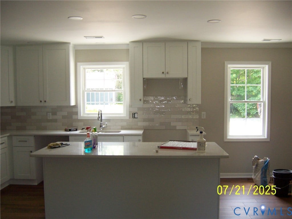 1805 Liesfeld Parkway, Henrico, VA 23060 Kitchen featuring dark wood-style flooring, light countertops, a center island, decorative backsplash, and crown molding