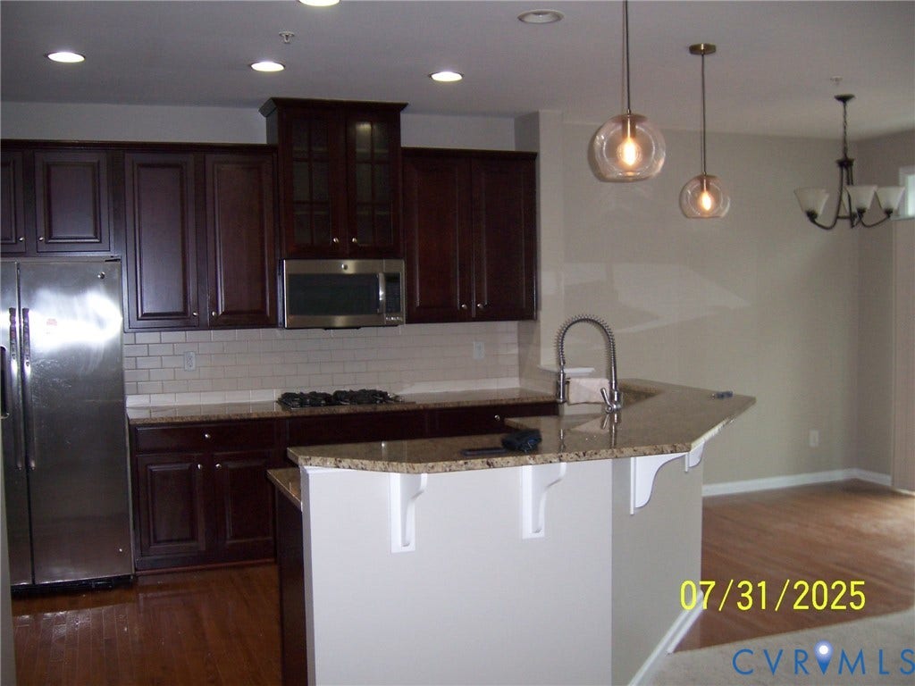 1805 Liesfeld Parkway, Henrico, VA 23060 Kitchen featuring stainless steel appliances, dark wood-style flooring, a breakfast bar, decorative backsplash, and recessed lighting