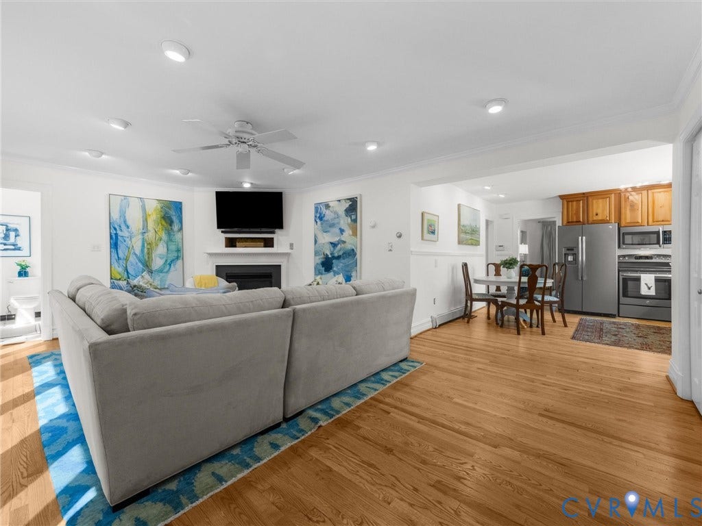 Hardwood flooring throughout, recessed lighting, and a ceiling fan