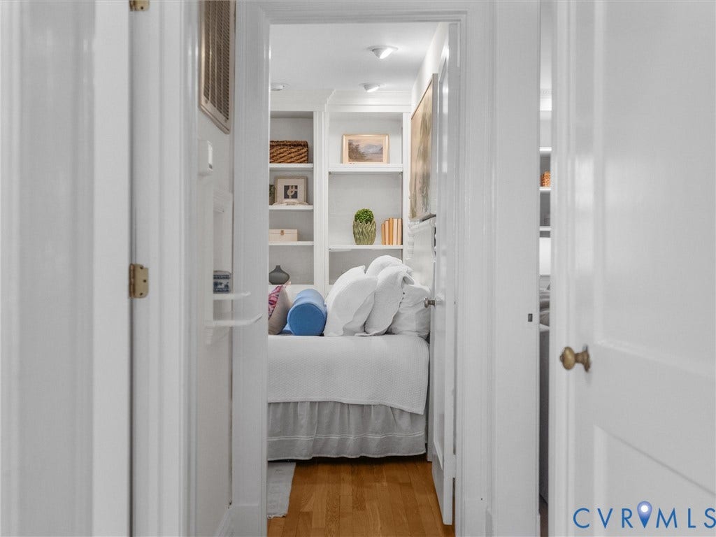 Hardwood-finish flooring, built-in shelving, recessed lighting, and white trim