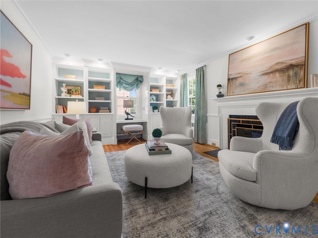 Built-in shelving, integrated desk space, decorative fireplace with mantel, and crown molding