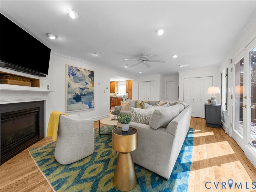 Hardwood flooring, recessed lighting, and a built-in fireplace with mantel