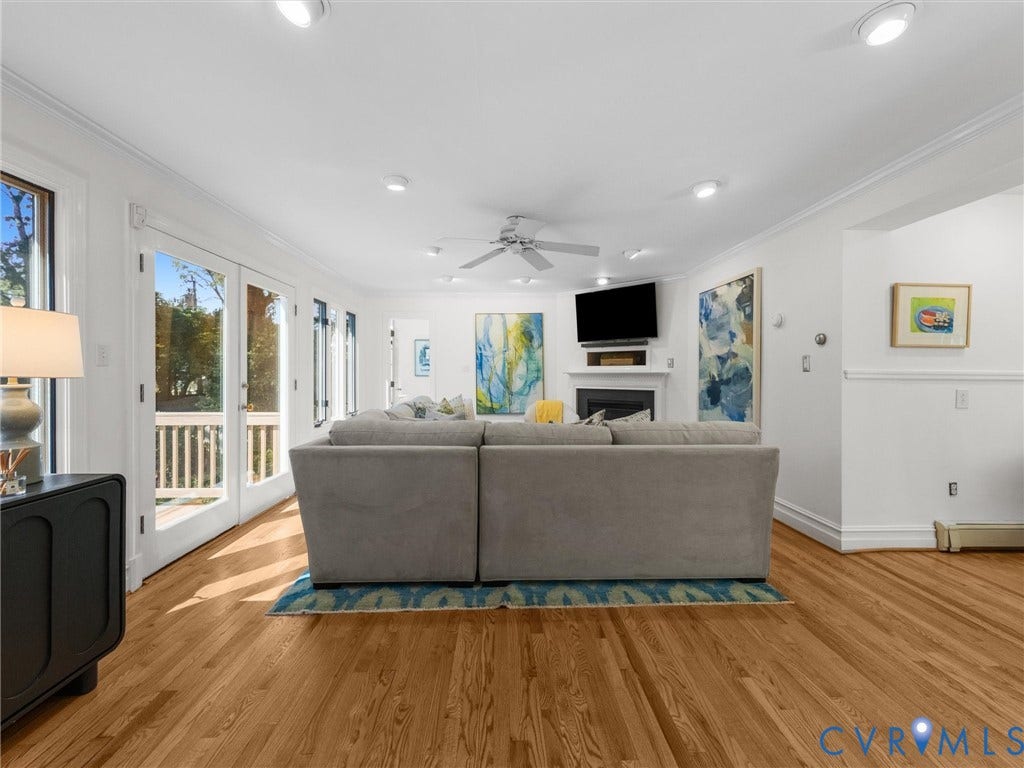 Hardwood flooring throughout, recessed lighting, ceiling fan, and French doors leading to an outdoor deck with white railings