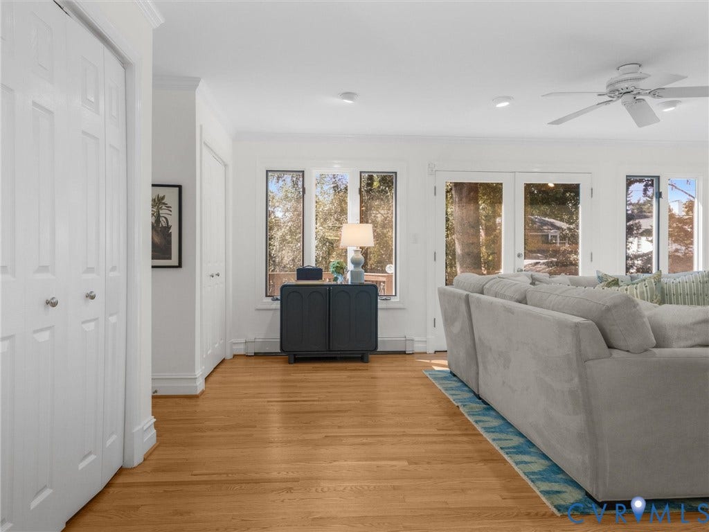 Hardwood flooring throughout, with white trim and crown molding