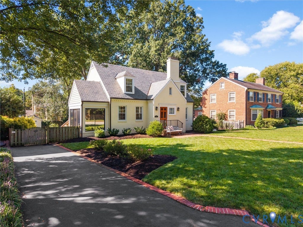 Cottage-style home featuring dormer windows, a prominent chimney, and a screened porch
