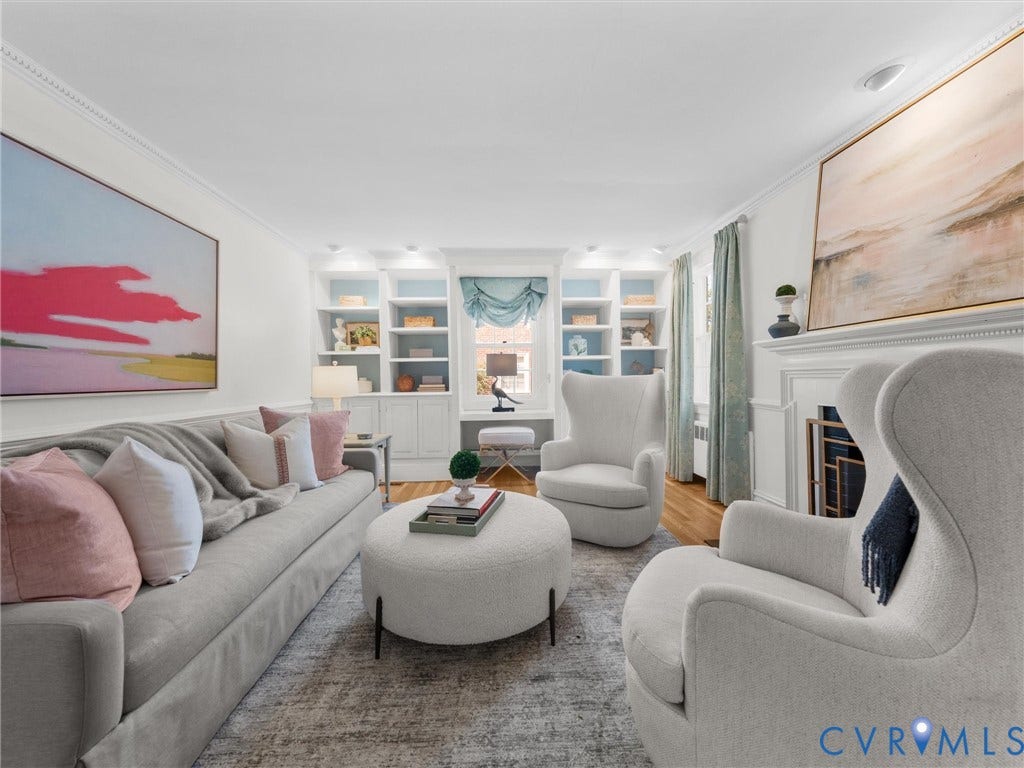 Recessed lighting illuminates built-in shelving, crown molding, and wood flooring