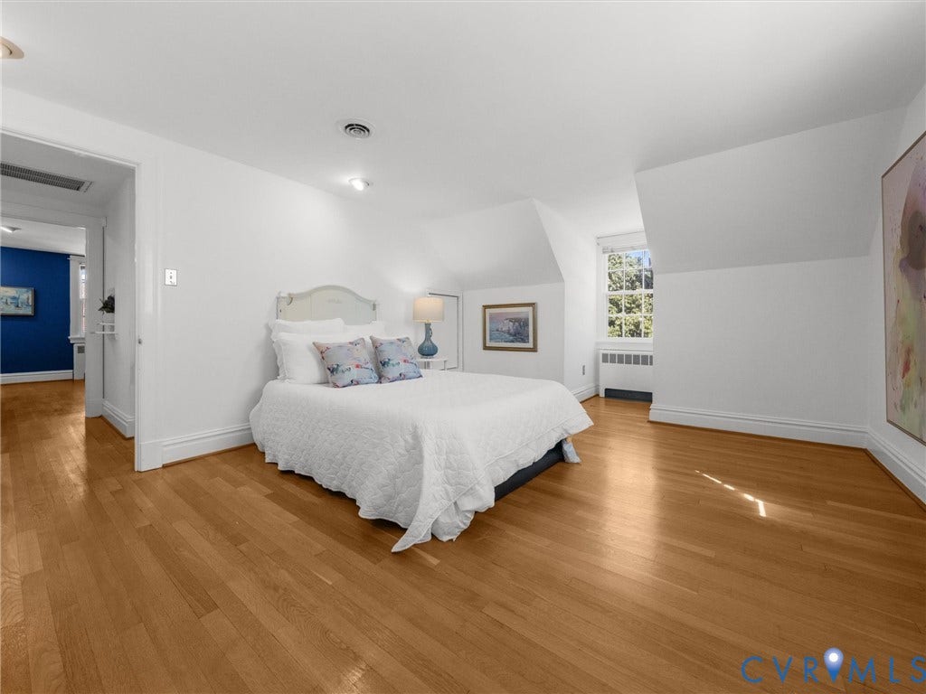 Wood-finish flooring, white walls, and a window with natural light