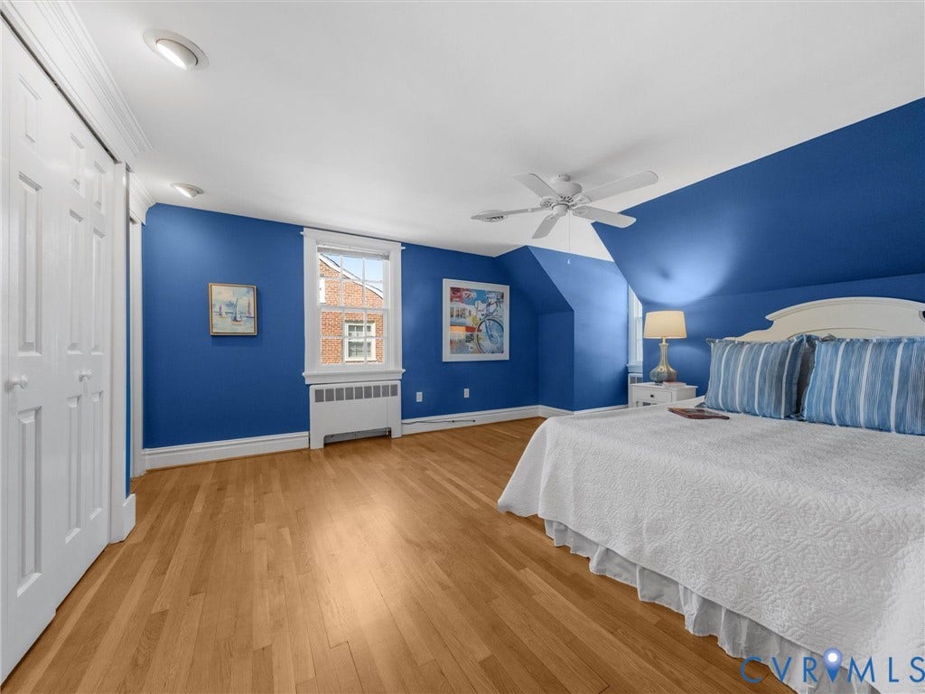 Hardwood flooring, recessed lighting, ceiling fan, architectural sloped ceiling, and built-in closet