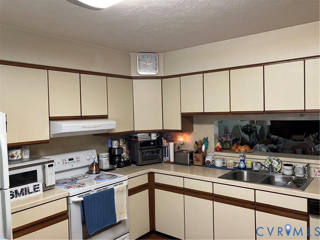12323 Frisco Drive, Henrico, VA 23233 Extensive upper and lower cabinetry with wood-finish trim, white appliances, and a dual basin sink