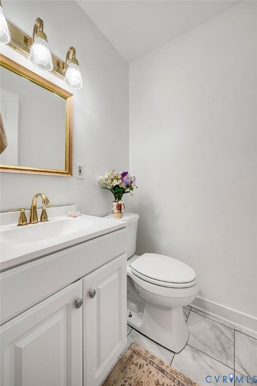 2409 Three Bridge Road, Rural, Powhatan, VA 23139 White vanity with panel cabinetry and a brass-finish faucet