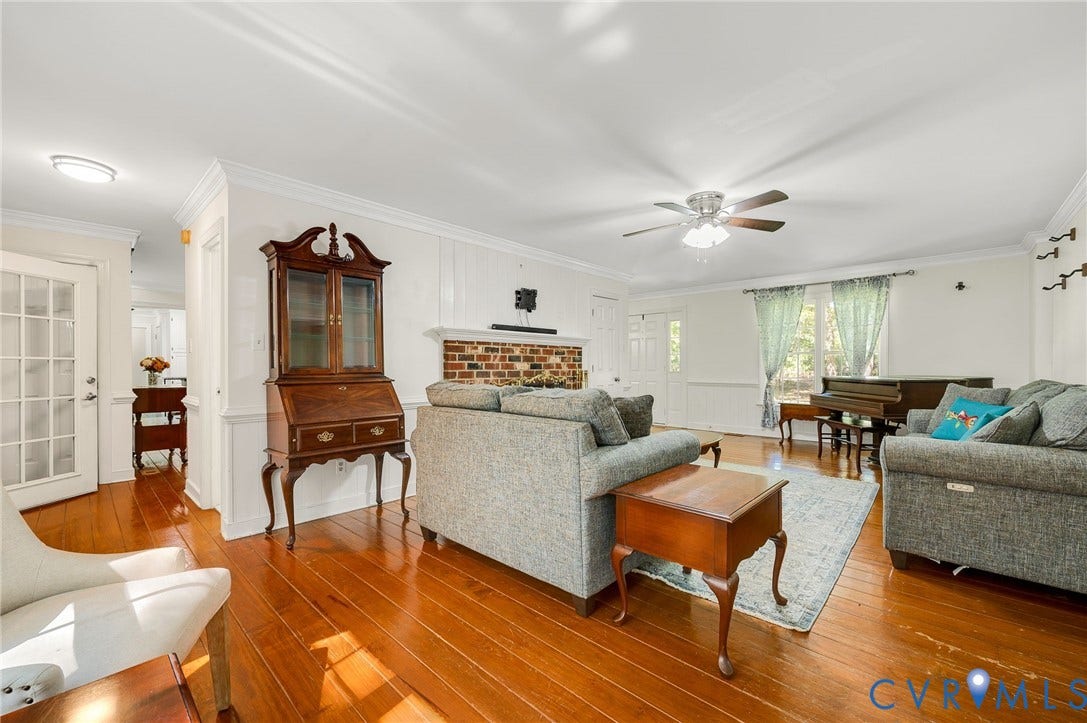 2409 Three Bridge Road, Rural, Powhatan, VA 23139 Hardwood flooring throughout, brick fireplace with a white mantel, crown molding, ceiling fan, and French doors