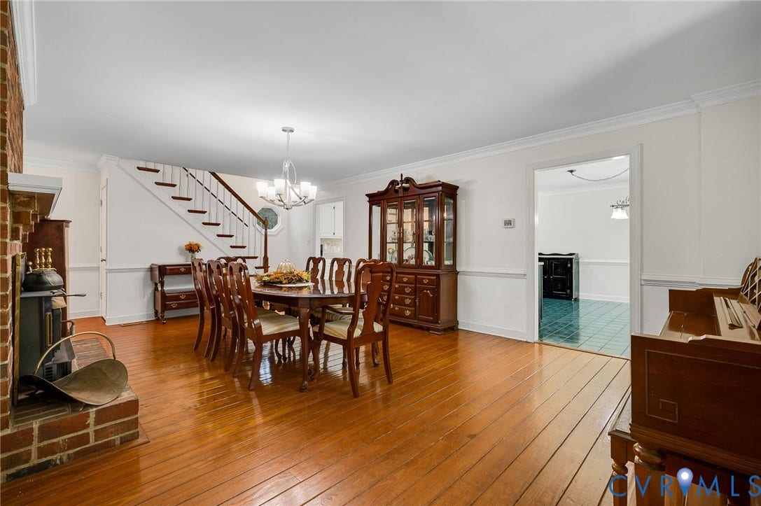 2409 Three Bridge Road, Rural, Powhatan, VA 23139 Hardwood flooring throughout, brick fireplace, staircase with wood handrail, crown molding, and wainscoting